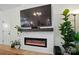 Modern fireplace with a mounted TV, built-in shelving, and stylish decor at 1212 Mason Way, Mount Holly, NC 28120