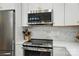 Stainless steel microwave and oven, marble backsplash, and gold hardware at 1212 Mason Way, Mount Holly, NC 28120