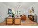 Bright open-concept living room featuring a fireplace, hardwood floors, and comfortable seating at 1212 Mason Way, Mount Holly, NC 28120