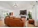 Spacious living room with high ceilings, fireplace, and leather sofa, perfect for relaxation at 1212 Mason Way, Mount Holly, NC 28120