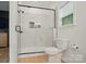 The main bathroom showcases a glass-enclosed shower with a tiled surround and a modern commode at 1212 Mason Way, Mount Holly, NC 28120