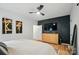 A beautifully decorated main bedroom features a stylish accent wall, ceiling fan, and modern decor at 1212 Mason Way, Mount Holly, NC 28120