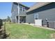 This view of the backyard features a grassy lawn, a seating area, and a fenced perimeter at 13359 Caite Ridge Rd, Davidson, NC 28036