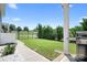 View of the backyard featuring a lawn, fence line, and a concrete patio area with grill at 13359 Caite Ridge Rd, Davidson, NC 28036
