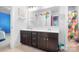 Bathroom view features a double sink, dark cabinets, and a view into another bathroom at 13359 Caite Ridge Rd, Davidson, NC 28036
