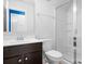 Bathroom featuring dark vanity, white sink and toilet, and a glass door shower at 13359 Caite Ridge Rd, Davidson, NC 28036