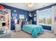 Charming bedroom with blue walls, stuffed animal decor, and a large window at 13359 Caite Ridge Rd, Davidson, NC 28036
