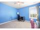 Spare bedroom with blue walls, a window, carpet, and a black desk at 13359 Caite Ridge Rd, Davidson, NC 28036