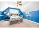 This spacious bedroom has carpet, a large bed, blue walls, and a ceiling fan at 13359 Caite Ridge Rd, Davidson, NC 28036