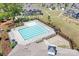 Overhead shot of the community pool, complete with lounge area, umbrellas, and neatly kept lawns at 13359 Caite Ridge Rd, Davidson, NC 28036