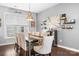 Elegant dining room with a large table, seating for eight, and stylish decor at 13359 Caite Ridge Rd, Davidson, NC 28036