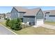 Exterior view of home showcasing the siding, trim, windows, garage, and well-maintained landscaping at 13359 Caite Ridge Rd, Davidson, NC 28036