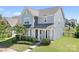 Charming two-story home with gray siding, manicured landscaping, and a welcoming front porch at 13359 Caite Ridge Rd, Davidson, NC 28036