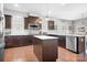 Well-equipped kitchen with stainless steel appliances, dark cabinets, and an island at 13359 Caite Ridge Rd, Davidson, NC 28036