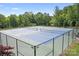 Fenced tennis courts surrounded by lush greenery, offering an active lifestyle in a serene setting at 13359 Caite Ridge Rd, Davidson, NC 28036