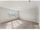 Bright bedroom featuring three windows offering natural light and neutral carpet at 1359 Russell St, Rock Hill, SC 29730