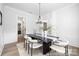 Contemporary dining room with a black table, stylish chairs, and wainscoting at 1359 Russell St, Rock Hill, SC 29730