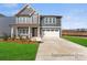 Two-story home showcasing a beautifully landscaped yard and a mix of siding and shingle exterior details at 1359 Russell St, Rock Hill, SC 29730