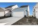 Attached two car garage with concrete driveway nestled between neighboring homes and fresh landscaping at 1359 Russell St, Rock Hill, SC 29730