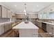 Kitchen with stainless steel appliances, custom cabinets, quartz counters, and a tile backsplash at 1359 Russell St, Rock Hill, SC 29730