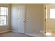Bright bedroom with plush carpet features a large window and white door at 1367 Springview Ct, Rock Hill, SC 29732
