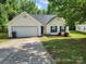 Charming single-story home with a well-maintained lawn, two-car garage, and delightful blue shutters at 1367 Springview Ct, Rock Hill, SC 29732