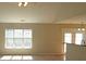 Open living area with plenty of natural light, featuring a kitchen bar and view of the backyard at 1367 Springview Ct, Rock Hill, SC 29732