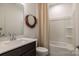 Cozy bathroom featuring a vanity with a quartz countertop, and a shower and bathtub combo at 14015 Penbury Ln # 373, Charlotte, NC 28278