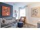 Modern Bedroom featuring a grey crib, stylish chair, and playful artwork on a calming blue accent wall at 14015 Penbury Ln # 373, Charlotte, NC 28278