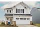Charming two-story home featuring white siding, black shutters, and an attached two-car garage at 14015 Penbury Ln # 373, Charlotte, NC 28278