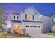 Charming two-story home featuring white siding, black shutters, and an attached two-car garage during twilight at 14015 Penbury Ln # 373, Charlotte, NC 28278