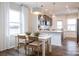 Bright kitchen dining area with a white table and seating, open to the kitchen space at 14015 Penbury Ln # 373, Charlotte, NC 28278