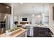 Bright kitchen with stainless steel appliances and a large center island that overlooks the living room at 14015 Penbury Ln # 373, Charlotte, NC 28278