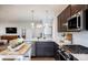 Open-concept kitchen featuring stainless steel appliances, a gas range, and a large island at 14015 Penbury Ln # 373, Charlotte, NC 28278