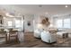Bright and airy living room with hardwood floors and an open layout connecting to the dining area and kitchen at 14015 Penbury Ln # 373, Charlotte, NC 28278