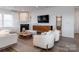 Sophisticated living room featuring a modern fireplace, hardwood floors, and comfortable seating for a relaxing atmosphere at 14015 Penbury Ln # 373, Charlotte, NC 28278