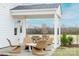 Charming covered patio offers a relaxing outdoor retreat with stylish furniture and scenic backyard views at 14015 Penbury Ln # 373, Charlotte, NC 28278