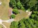 Overhead aerial shot displays the house, mature trees, chicken coop, and expansive yard at 145 Mccreek Dr, China Grove, NC 28023