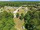 Aerial view of property showcasing the home's location nestled among lush greenery and neighboring residences at 145 Mccreek Dr, China Grove, NC 28023