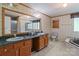 Bathroom featuring a double sink vanity, patterned wallpaper, and tub shower combo at 145 Mccreek Dr, China Grove, NC 28023