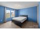 Bedroom with two windows allowing natural light, and bed on carpeted floor at 145 Mccreek Dr, China Grove, NC 28023