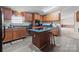 Classic kitchen featuring wood cabinets, center island with seating and modern flooring at 145 Mccreek Dr, China Grove, NC 28023
