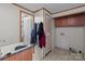 Laundry room featuring storage cabinets, linoleum flooring, and wall-mounted sink at 145 Mccreek Dr, China Grove, NC 28023