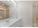 Bright bathroom featuring double sinks, a large mirror, and a glass-enclosed shower at 155 Harper Lee St, Davidson, NC 28036