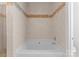 Tiled bathtub with decorative accents in bathroom at 155 Harper Lee St, Davidson, NC 28036