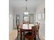 Charming dining area featuring a round table, chandelier, and natural light from nearby windows and a glass door at 155 Harper Lee St, Davidson, NC 28036