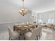 Elegant dining room with a large wooden table, chandelier, and a cozy fireplace at 155 Harper Lee St, Davidson, NC 28036
