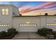 Townhome exterior with three garages and a beautifully sunset at 155 Harper Lee St, Davidson, NC 28036