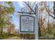 A sign provides information about the South Prong Rocky River Greenway trail access at 155 Harper Lee St, Davidson, NC 28036