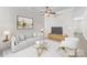 Bright living room boasts a modern design with a plush sofa and a stylish ceiling fan at 155 Harper Lee St, Davidson, NC 28036